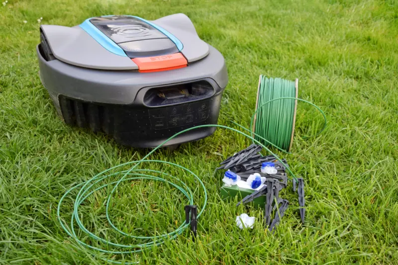 Robotic mower boundary cable repair scene with 314 connectors and green perimeter wire