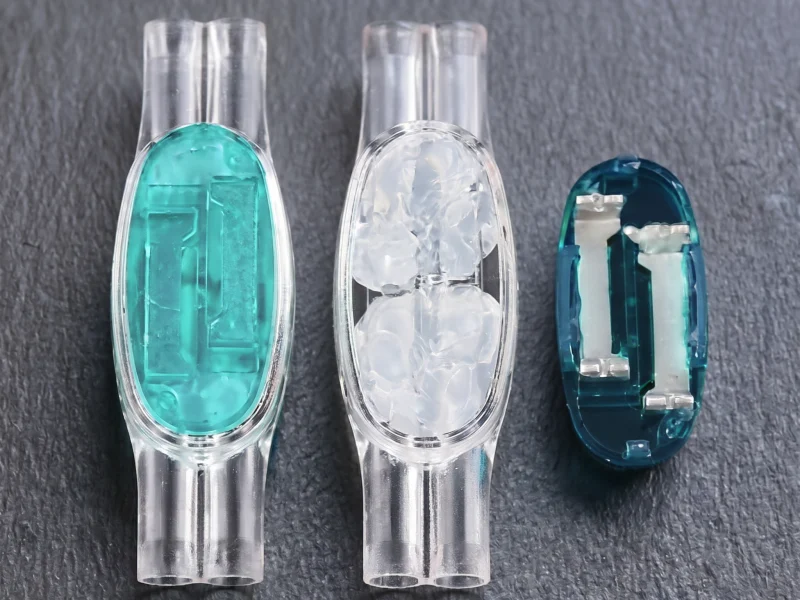U1B gel-filled telecom drop wire connector with open cap and internal contact elements